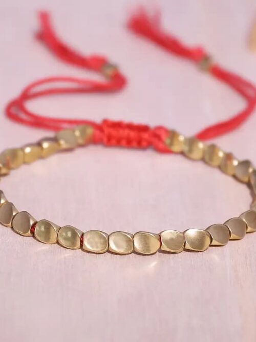 Pulsera tibeana hilo rojo y cobre