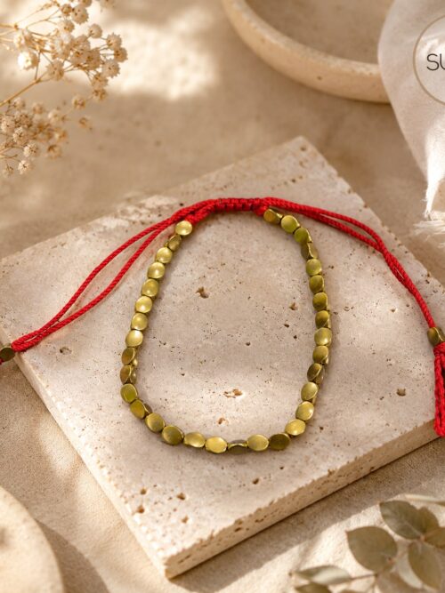 Pulsera tibeana hilo rojo y cobre